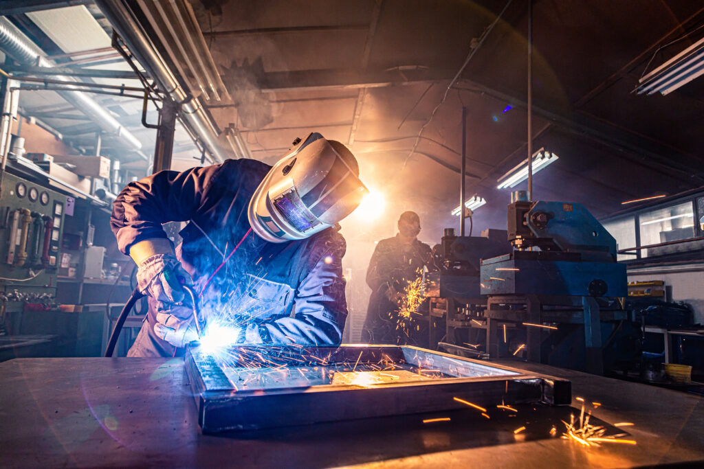 The,Two,Handymen,Performing,Welding,And,Grinding,At,Their,Workplace