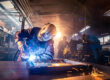 The,Two,Handymen,Performing,Welding,And,Grinding,At,Their,Workplace