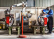 Man,And,Robotic,Machine,Work,Together,Inside,Industrial,Building