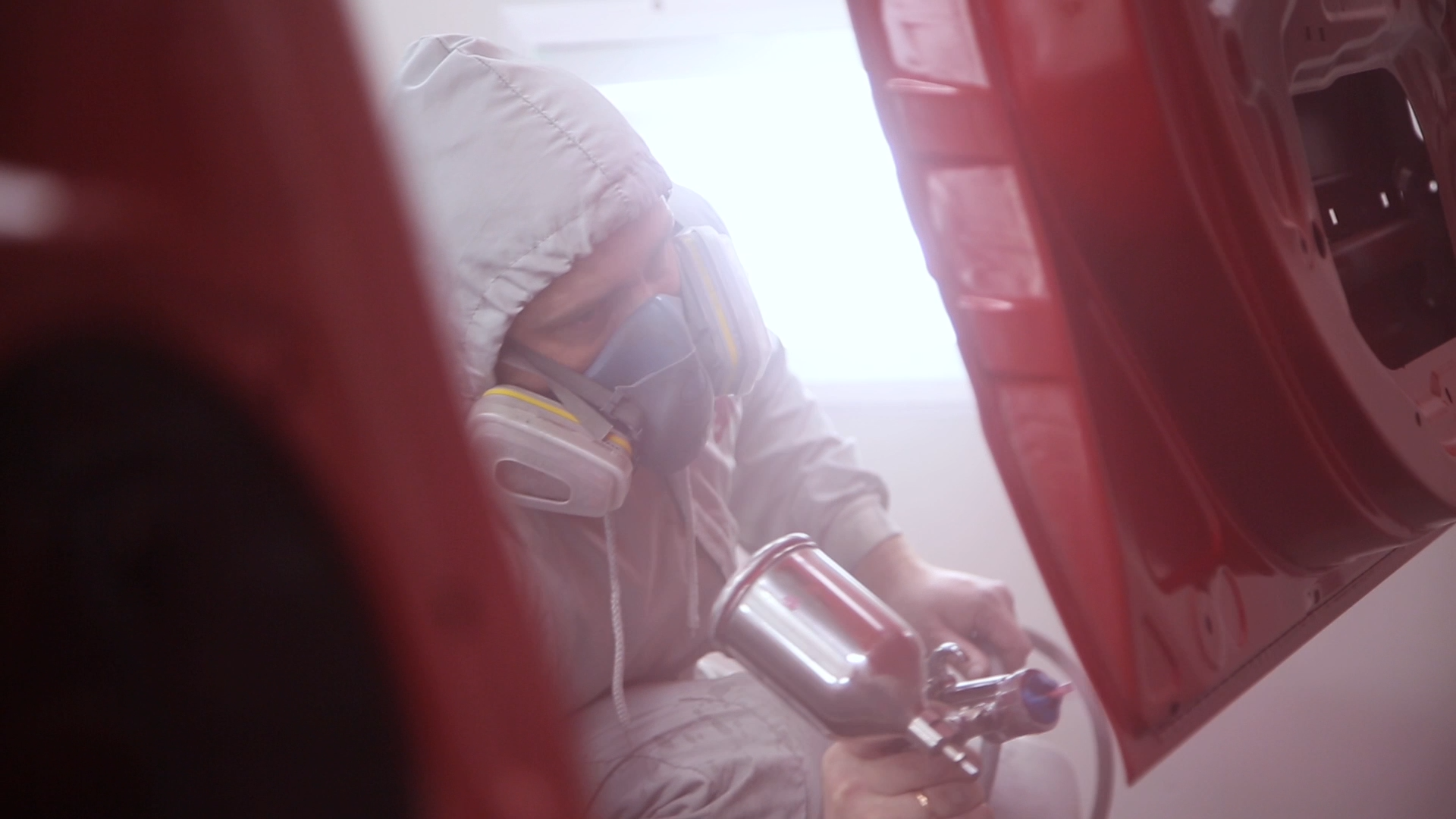 Person spray painting in real environment Person spray painting in real environment