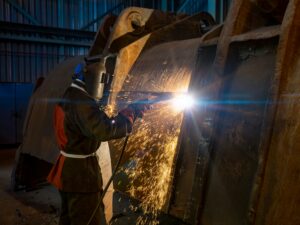 heavy industry Welder working on large industrial metal equipment