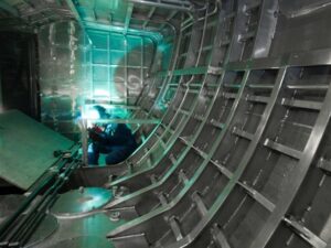 shipbuilding Welder working inside a ship hull structure