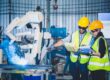 Engineers,Team,Mechanic,Using,Computer,Controller,Robotic,Arm,For,Welding