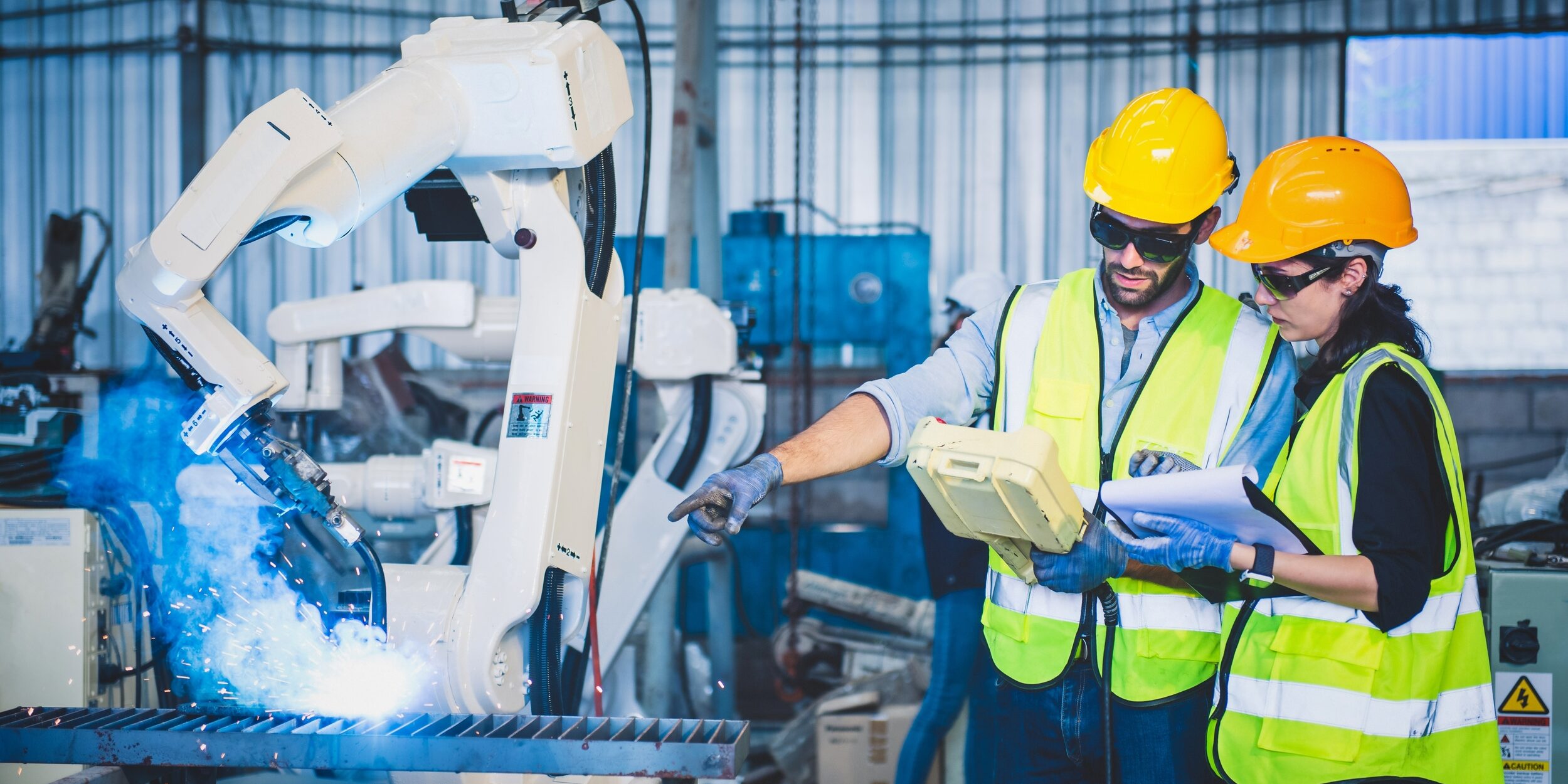 Engineers,Team,Mechanic,Using,Computer,Controller,Robotic,Arm,For,Welding